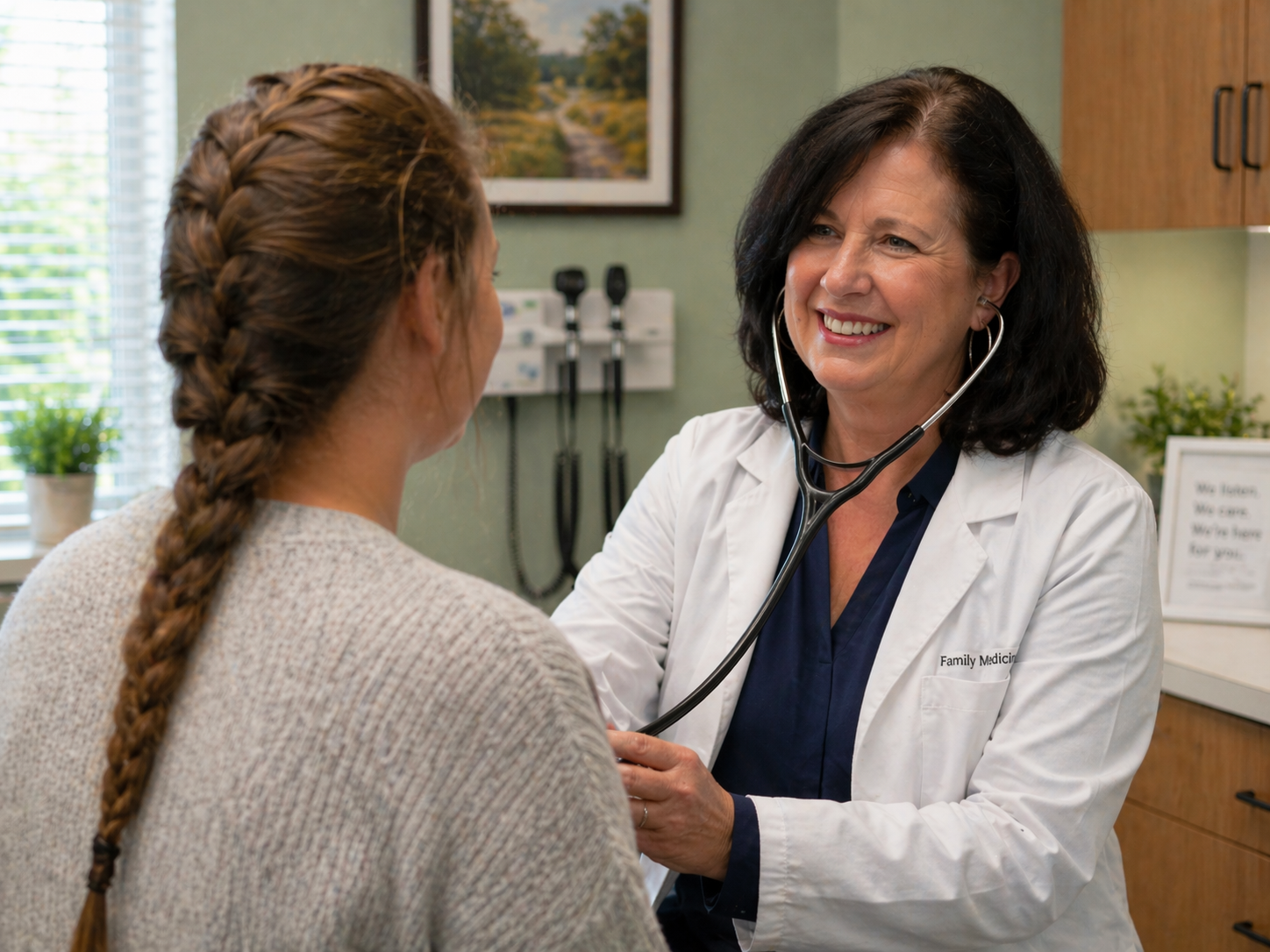 Provider with a patient in the exam room at Holden Family Care